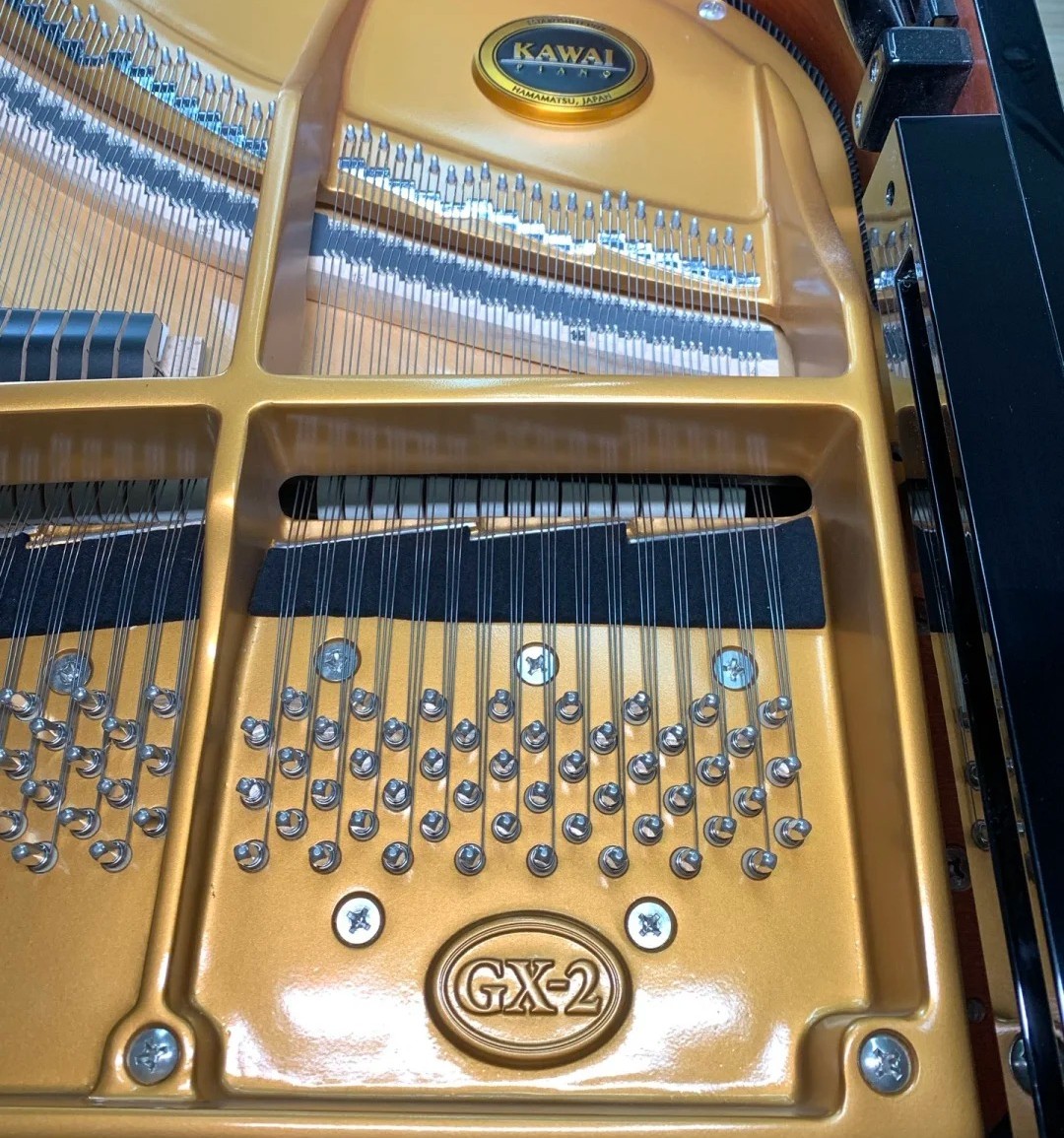 Détail intérieur du Kawai GX-2 : cadre V-Pro doré estampillé GX-2, chevilles d'accord, agraffes et cordes du sommier SOLID, médaillon Kawai Hamamatsu Japan